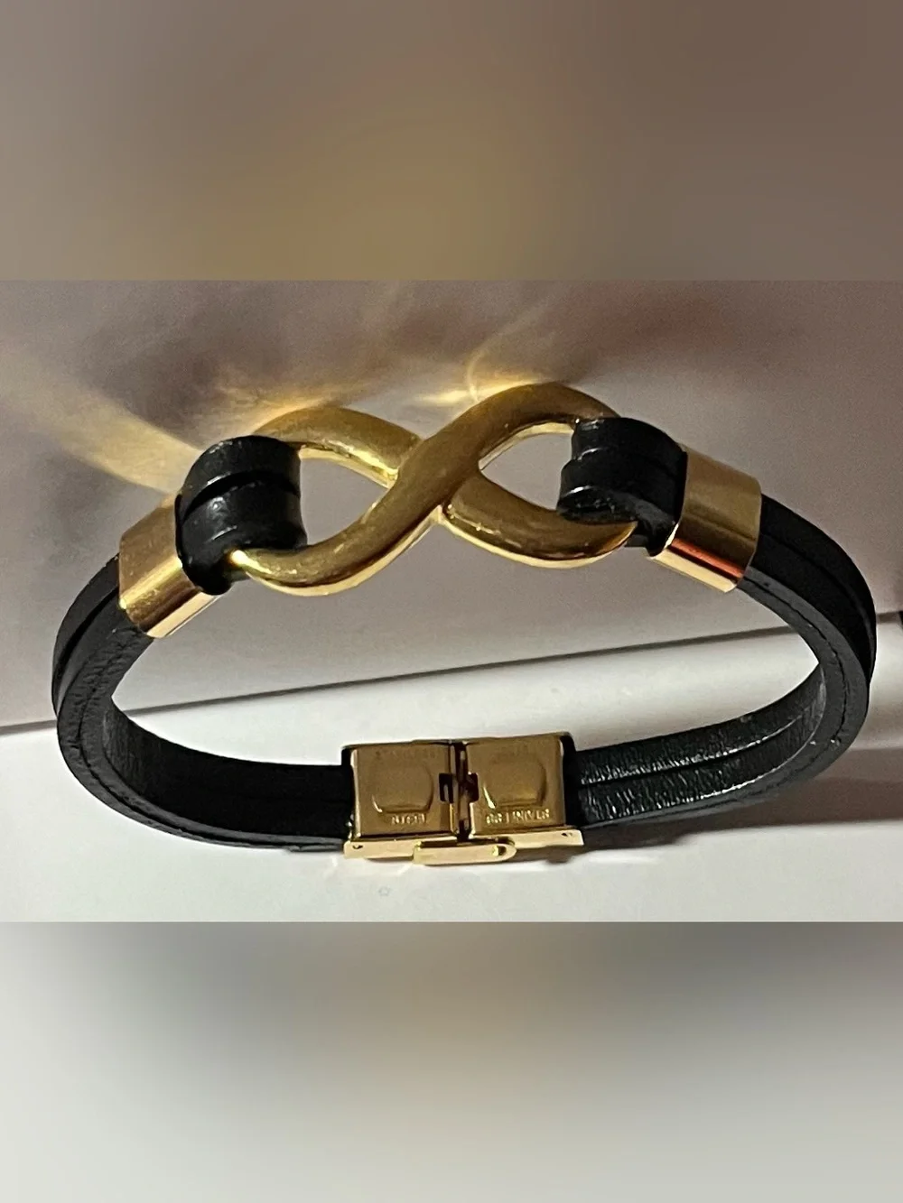 Black Faux Leather Bracelet with Gold tone Infinity Link, and hardware. (NWOT)